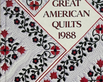 May include: A book cover titled "Great American Quilts 1988". The cover features a white background with a quilted pattern and decorative floral vines in black, red, and dark purple. The title is in a diamond shape.