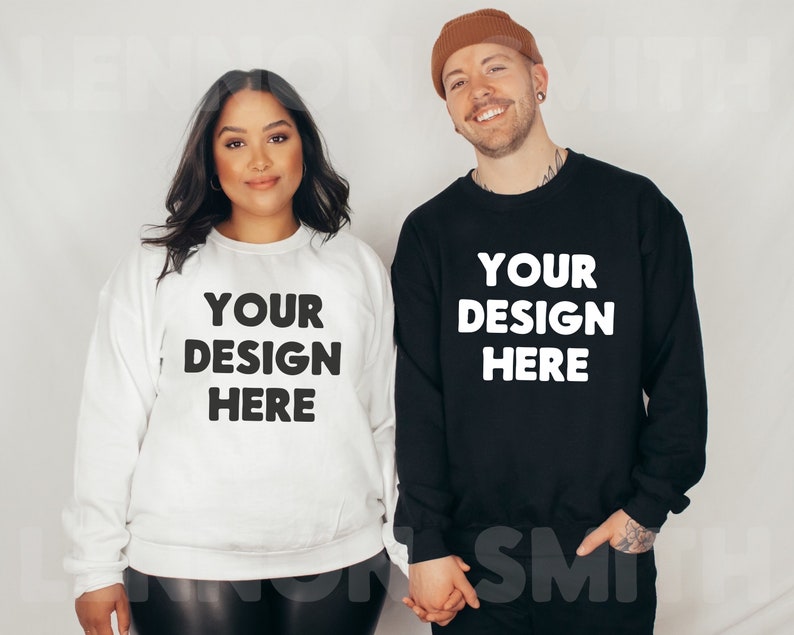 May include: Two people wearing black and white sweatshirts with the text "YOUR DESIGN HERE" printed on the front. The person on the left is wearing a white sweatshirt and the person on the right is wearing a black sweatshirt.