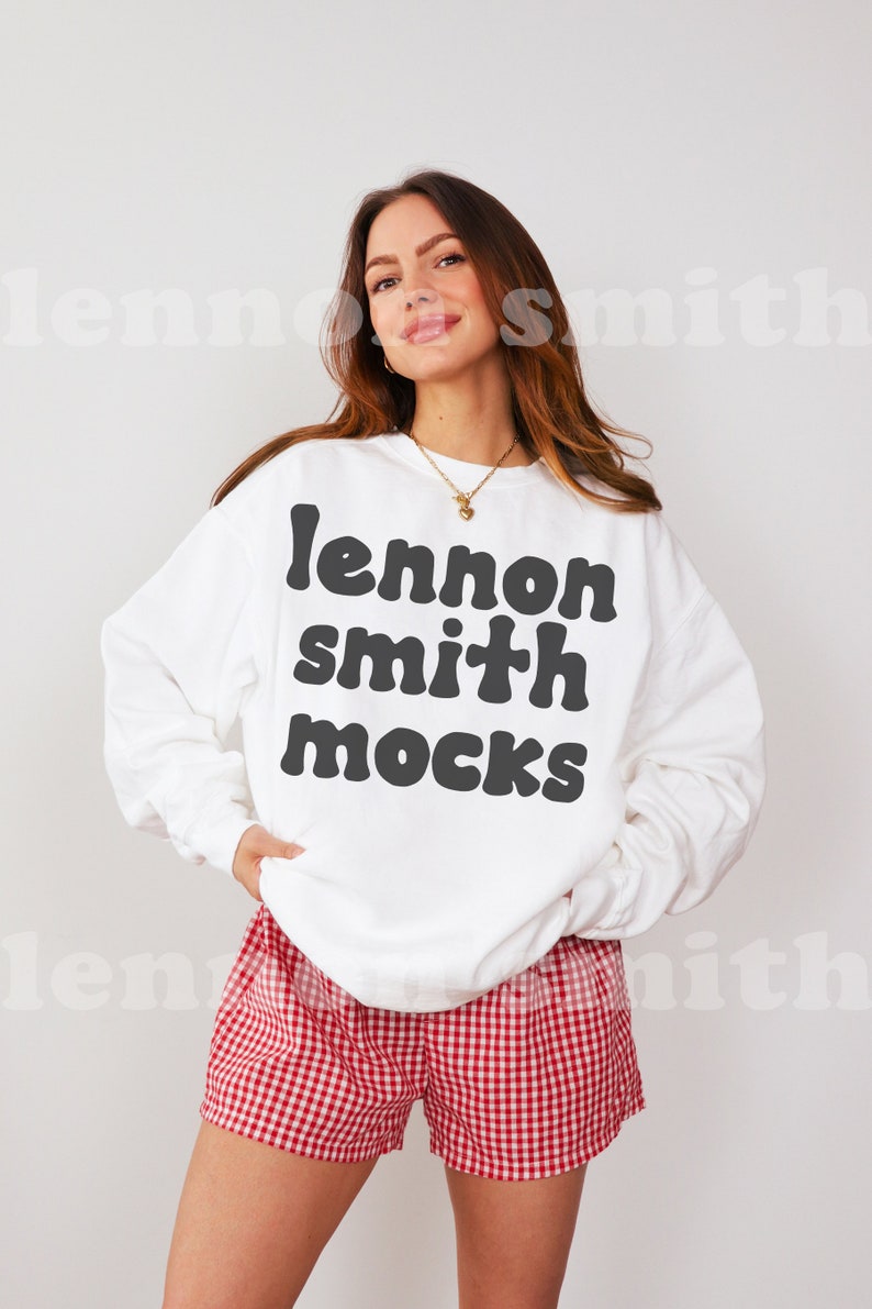 Może przedstawiać: Biała bluza z czarnym napisem "lennon smith mocks" na kobiecie w czerwono-białych szortach w kratkę.