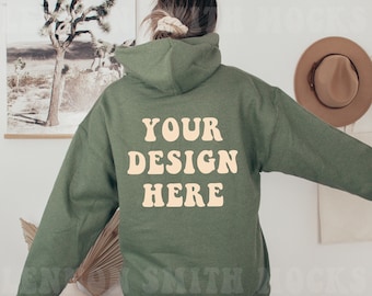 May include: A green hooded sweatshirt with the text "YOUR DESIGN HERE" in a retro font on the back.