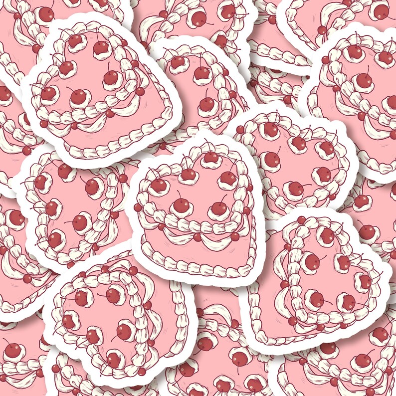 K&ouml;nnte beinhalten: Ein Muster aus rosa herzf&ouml;rmigen Kuchen mit wei&szlig;em Frosting und roten Kirschen. Die Kuchen sind in einem sich wiederholenden Muster angeordnet.