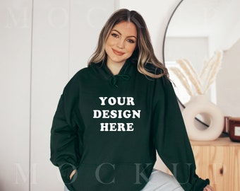 May include: A dark green hooded sweatshirt with the text "YOUR DESIGN HERE" in white.