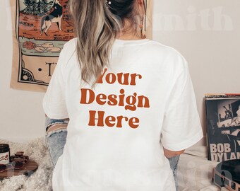 May include: White t-shirt with the text "Your Design Here" in orange on the back.