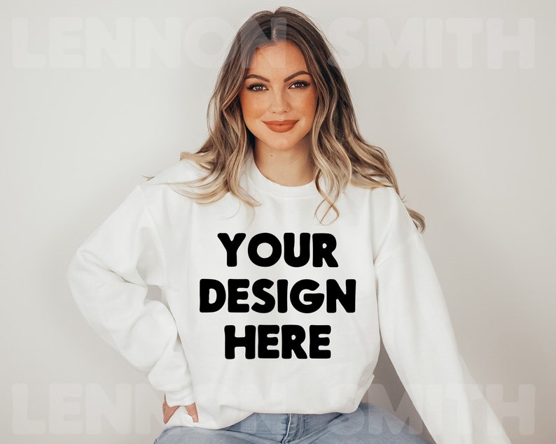 May include: A white sweatshirt with the text "YOUR DESIGN HERE" printed in black.