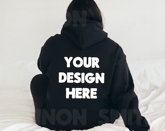 May include: Black hoodie with the text "YOUR DESIGN HERE" printed in white on the back.