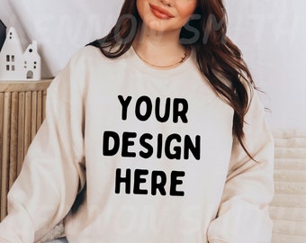 May include: A cream colored sweatshirt with the text "YOUR DESIGN HERE" printed in black.
