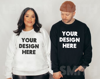 May include: Two people wearing white and black sweatshirts with the text "YOUR DESIGN HERE" printed on the front. The person on the left is wearing a white sweatshirt and the person on the right is wearing a black sweatshirt.