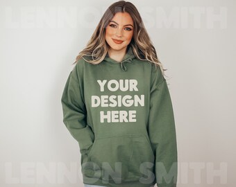 May include: A green hooded sweatshirt with the text "YOUR DESIGN HERE" printed in white on the front.