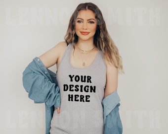 May include: A woman wearing a gray tank top with the text "YOUR DESIGN HERE" in black. She is wearing a blue denim jacket over the tank top.