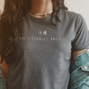 she&#39;s flowers and fire ® - butterflies rising - black heather tshirt center logo