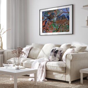a living room with a white couch and a painting on the wall