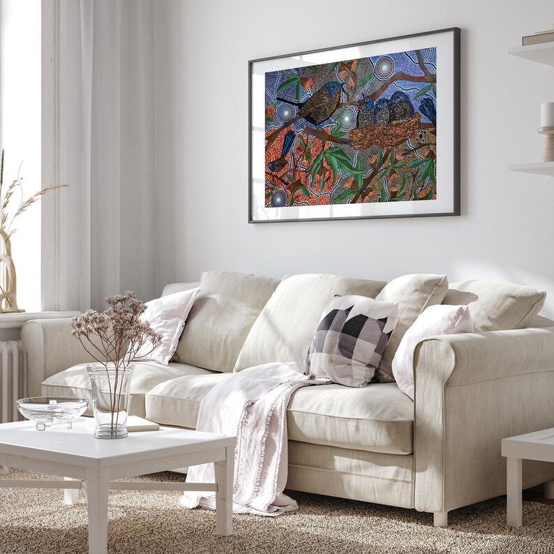 a living room with a white couch and a painting on the wall