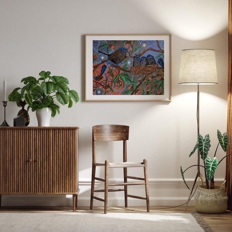 a painting hangs on the wall next to a chair