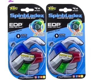 2 unidades de Spinner antiestrés con luz LED de doble cara Zing™ Spinzipz, verde y azul. NUEVO. 2 unidades en el lote