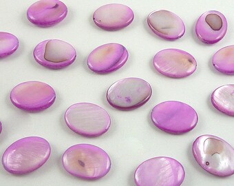 May include: A collection of 18 oval-shaped, iridescent purple shell beads. The beads have a smooth, polished surface and a subtle shimmer.