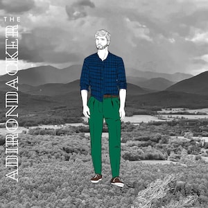 Könnte beinhalten: Ein Mann in einem blauen karierten Hemd und grünen Hosen steht vor einer Berglandschaft. Der Text "THE ADIRONDACKER" ist vertikal auf der linken Seite des Bildes geschrieben.