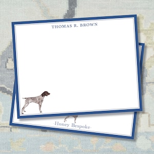 May include: A stack of white stationery cards with a blue border. The top card features a brown and white dog illustration and the text "THOMAS R. BROWN". The bottom card has the text "Honey Bespoke".