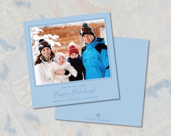 May include: Light blue holiday card with a family photo inside a blue border. The card reads "baby it's cold outside, Happy Holidays!" and includes the family's names. A second card is visible.