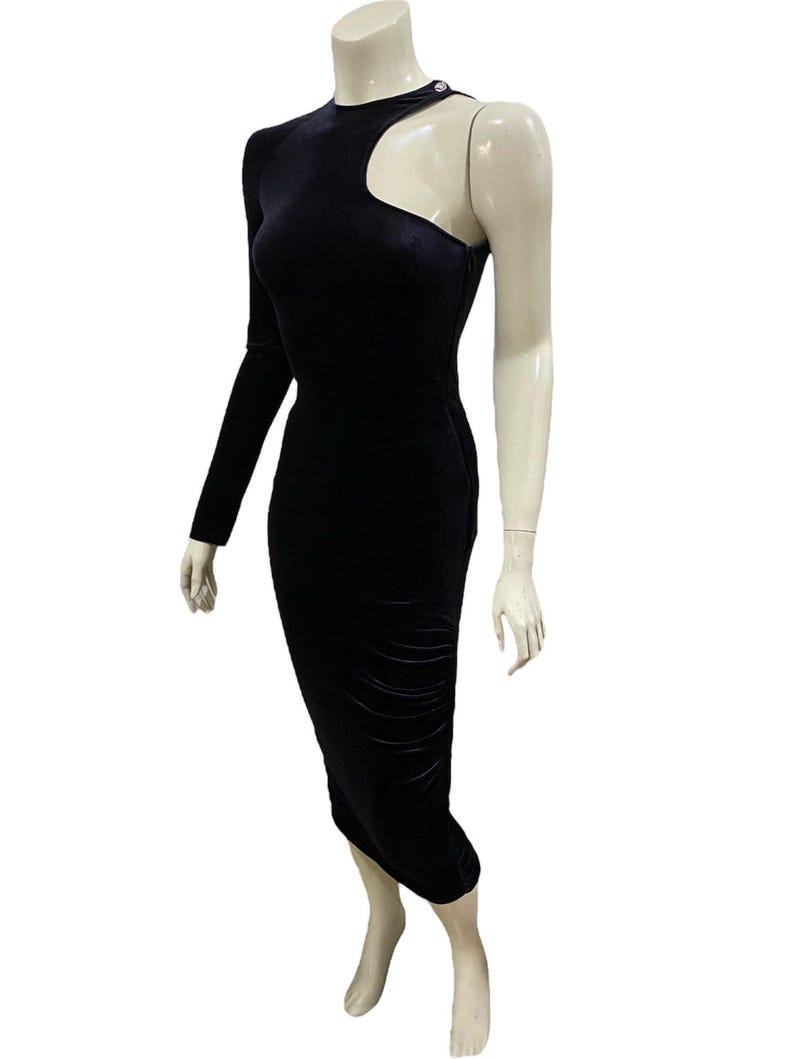 May include: A black velvet midi dress with a one-shoulder design and a cut-out detail at the shoulder.