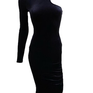 May include: A black velvet midi dress with a one-shoulder design and a single button detail.