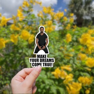 May include: A sticker featuring a man in a black shirt with the text "MAKE YOUR DREAMS COME TRUE!"