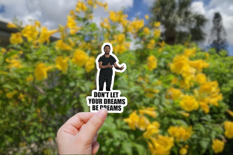 May include: A sticker featuring a man in a black shirt and jeans, with the text "Don't let your dreams be dreams".