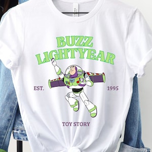a buzz lightyear t - shirt hanging on a clothes rack