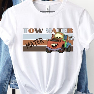 a white t - shirt with a tow truck on it