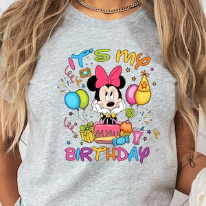 a woman wearing a mickey mouse birthday shirt