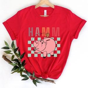 a red shirt with a pig on it