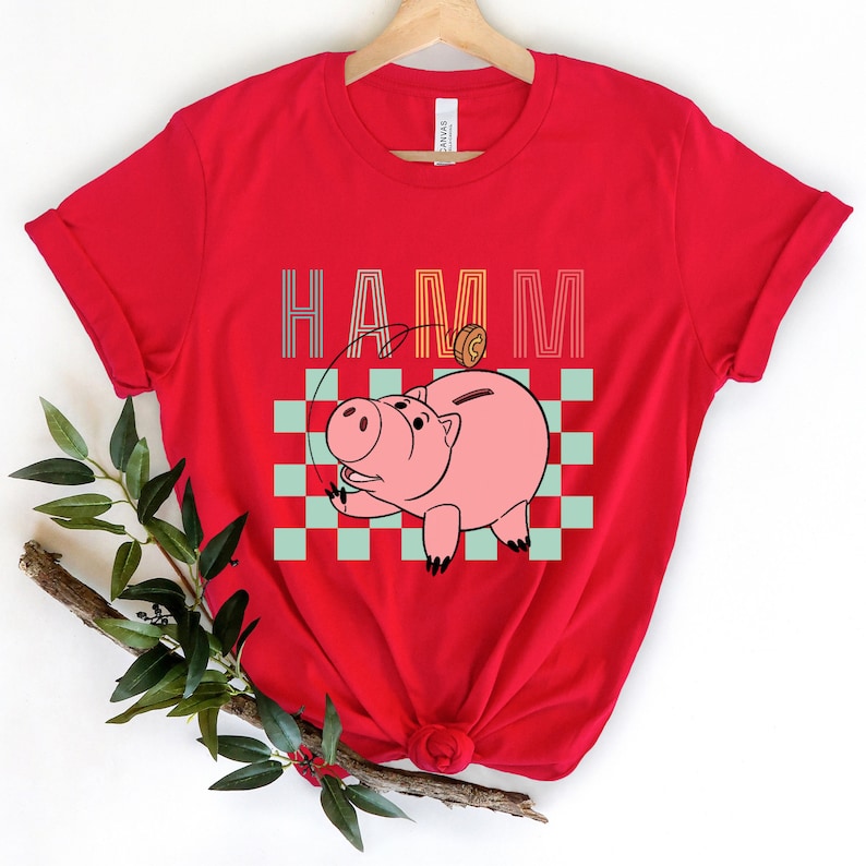 a red shirt with a pig on it