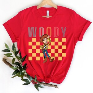 a red woody t - shirt with woody on it