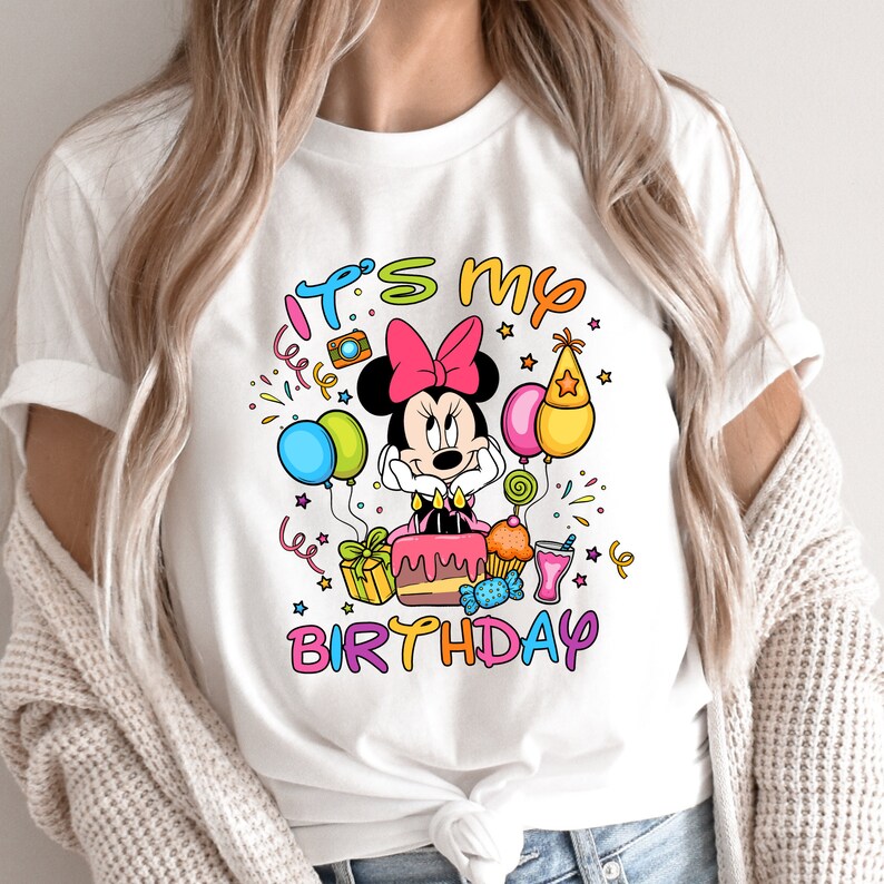 a woman wearing a mickey mouse birthday shirt