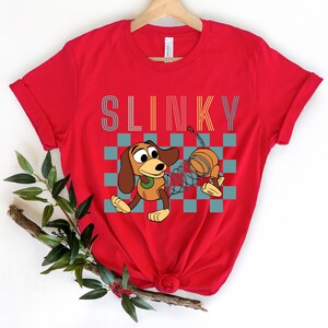 a red shirt with a cartoon dog on it
