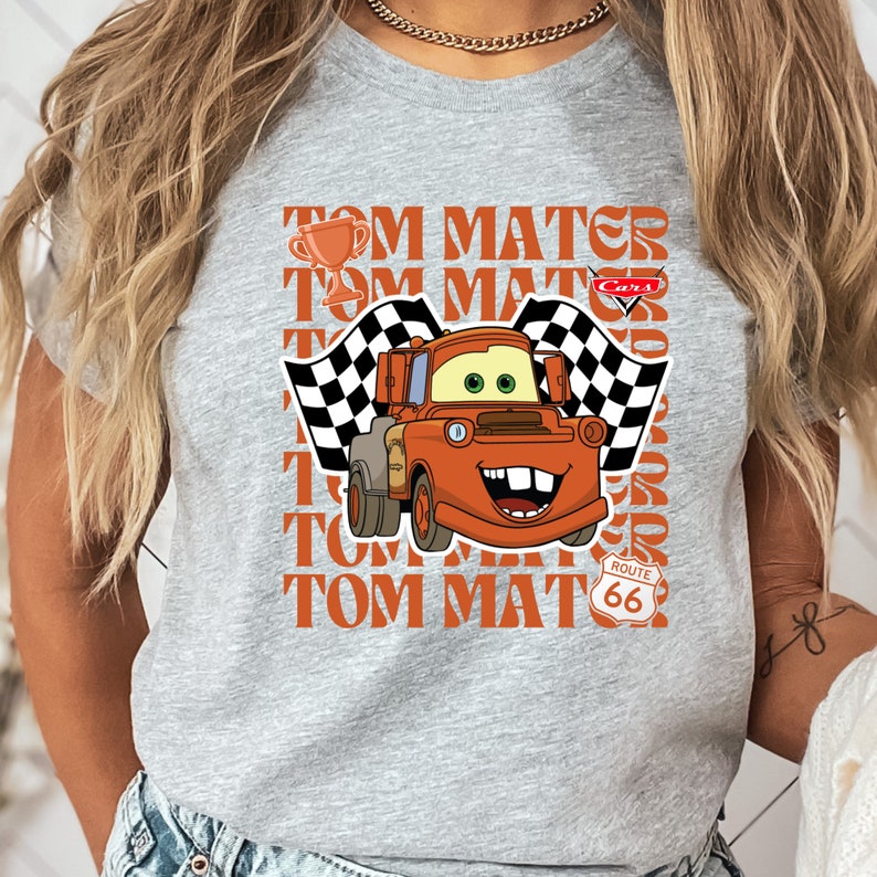 a woman wearing a gray shirt with a cartoon character on it