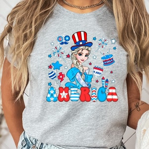 a woman wearing a gray shirt with a cartoon character on it