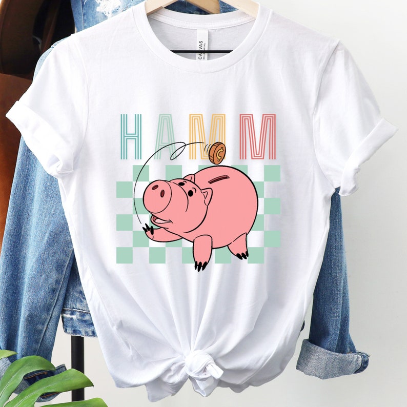 a white shirt with a pig on it