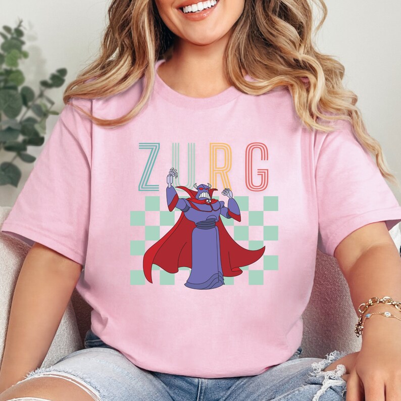 a woman sitting on a couch wearing a pink shirt