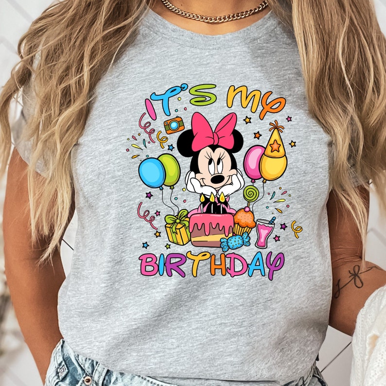 a woman wearing a mickey mouse birthday shirt