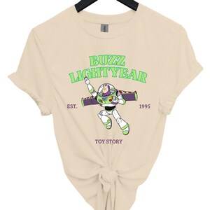 a women's t - shirt with the words buzz lightyear on it