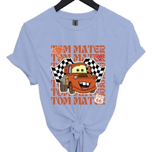 a blue shirt with a cartoon character on it