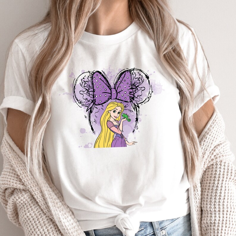a woman wearing a t - shirt with a picture of a princess on it