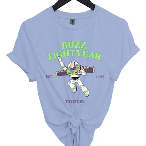 a blue buzz lightyear t - shirt on a hanger