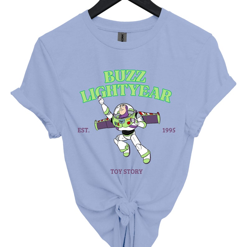 a blue buzz lightyear t - shirt on a hanger