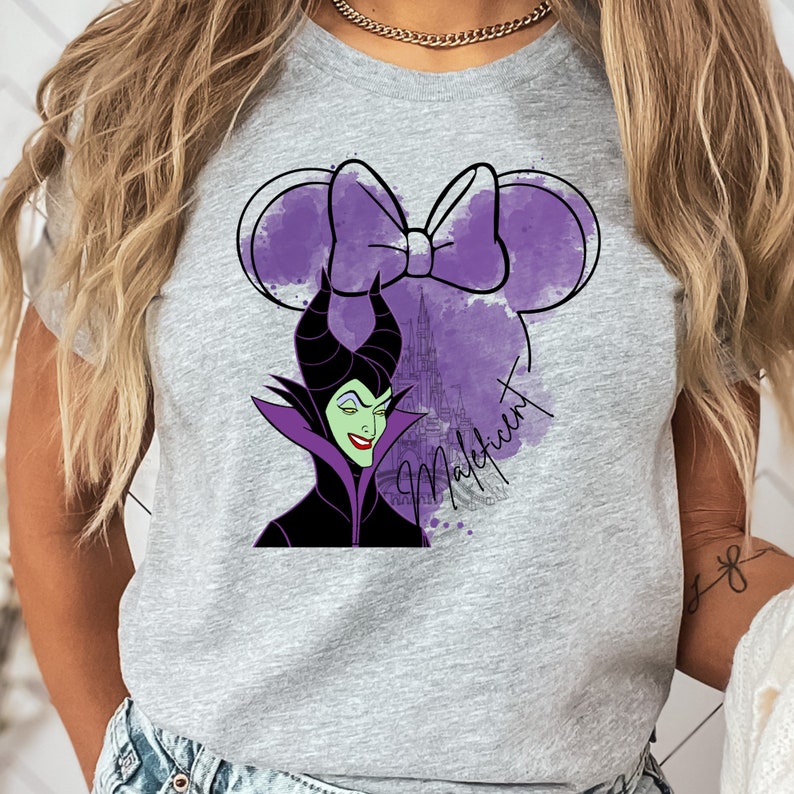 a woman wearing a grey shirt with a picture of an evil queen on it