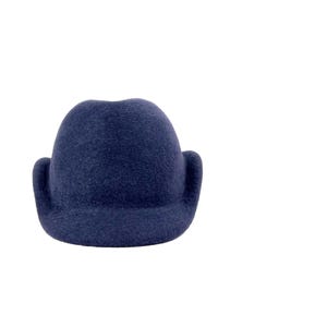 front view of a navy wool velour hat with a structured crown, mock ear flaps, and a short brim, displayed on a white background