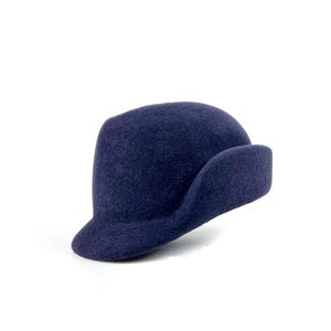 angle view of the navy sculpted velour hat, showing the short brim and sweeping side ear flap