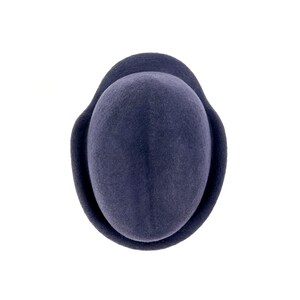 to- down view of the navy felt hat showing the deep center crease of the crown and the molded ear flap wrapping around the sides.