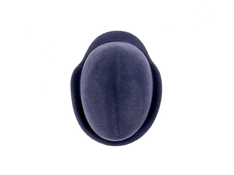 to- down view of the navy felt hat showing the deep center crease of the crown and the molded ear flap wrapping around the sides.