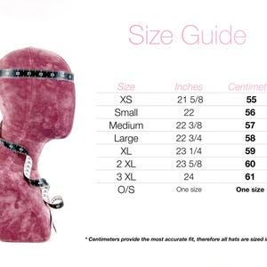 May include: A burgundy mannequin head with a measuring tape around it, displaying a size guide for hats. The guide lists sizes XS to 3XL, with corresponding measurements in inches and centimeters, ranging from 21 5/8 inches (55 cm) to 24 inches (61 cm).